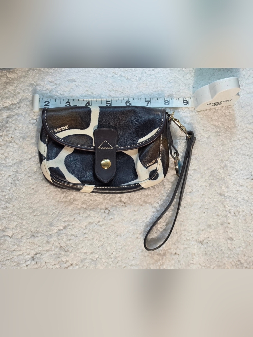 Dooney & Bourke giraffe print haircalf leather flap wristlet bag. 